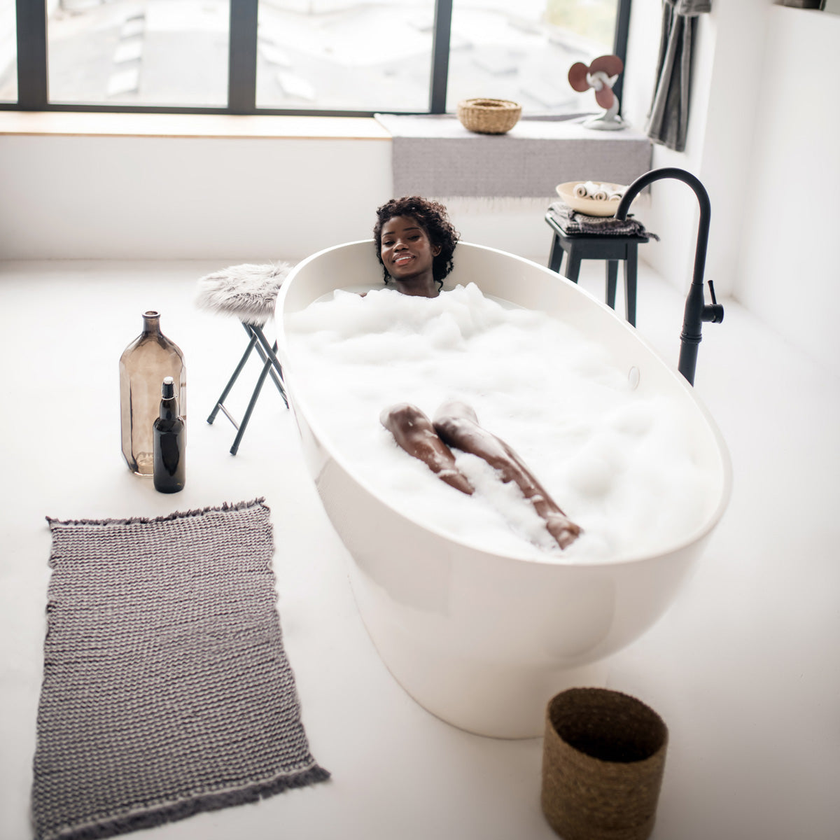 Woman soaking in bubble bath